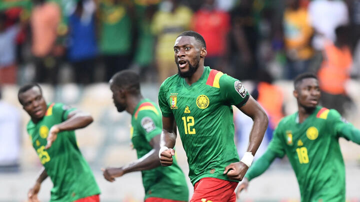 Cameroon's forward Karl Toko Ekambi (front) celebrates after scoring his team's first goal during the Africa Cup of Nations (CAN) 2021 quarter final football match between Gambia and Cameroon at the Japoma Stadium in Douala on January 29, 2022.